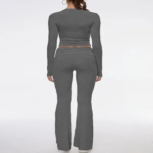 Back view of a grey long sleeve crop top and low-waist flare pants set for women.