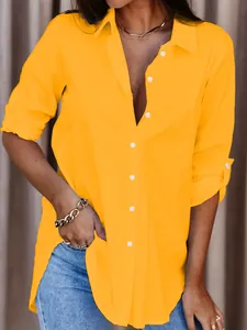 Elegant yellow button-up shirt for women, showing relaxed fit and casual style detail.