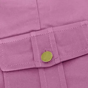 Macro view showing the cargo pocket detail and gold button on purple yoga pants
