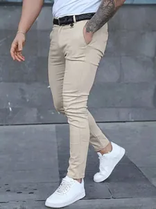 Men's slim fit khaki casual pants paired with white sneakers for a business casual look