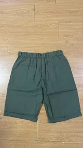 Detail view of olive green linen men's shorts with elastic waist and back pockets