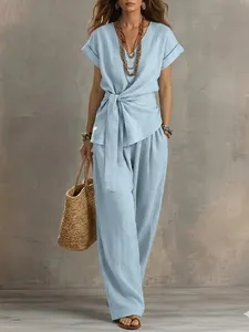 Casual light blue two-piece set featuring V-neck waist-tie top and wide-leg trousers