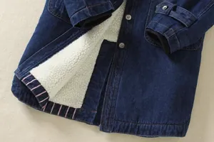 Detailed view of blue denim jacket with thick white sherpa fleece lining and metal buttons.