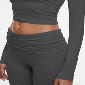Close-up detail of dark grey textured yoga set with crop top and low waist leggings
