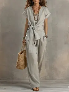 Detailed view of women's two-piece set with V-neck tie-waist top and matching trousers