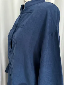 Close-up of navy blue linen-like shirt with traditional frog buttons and mandarin collar