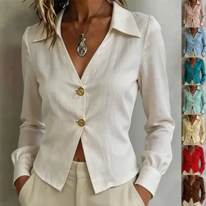 Detail view of a long-sleeve shirt with a diagonal placket and gold buttons