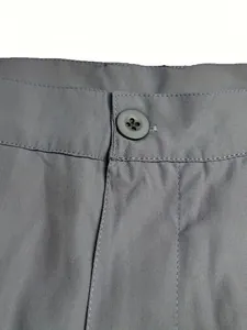 Close-up of gray men's casual shorts featuring a button closure and durable fabric texture.