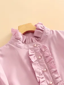 Elegant pink ruffled blouse with pearl buttons for professional business wear