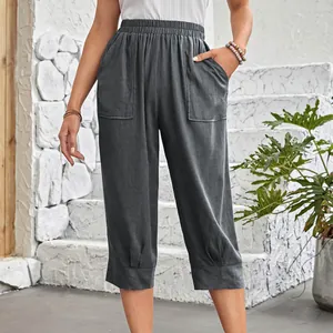 Close-up of women's cotton linen cropped pants with large front pockets and elastic waist