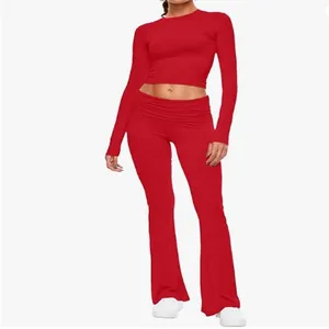Red two-piece set featuring long sleeve crew neck crop top and flared yoga pants