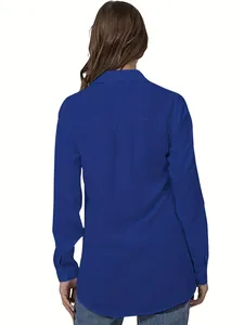 Detailed back view of an elegant cobalt blue long sleeve shirt with curved hemline