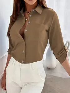 Detail view of khaki long sleeve lapel shirt featuring metal buttons and pocket.