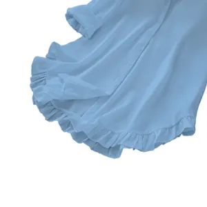 Close-up of the delicate ruffle hem detail on this elegant light blue casual shirt.