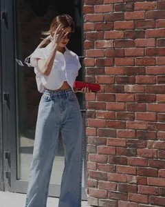 Urban street style view of a white cropped vest with large pockets and wide-leg jeans