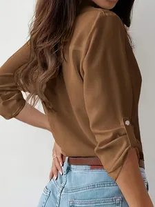 Side view of professional brown long sleeve shirt featuring metal button sleeve tab detail