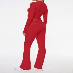 Detailed rear view of a vibrant red ribbed long-sleeve crop top and flared pants set.
