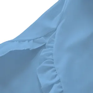 Detailed macro view showing the elegant ruffles on a light blue casual long-sleeved blouse
