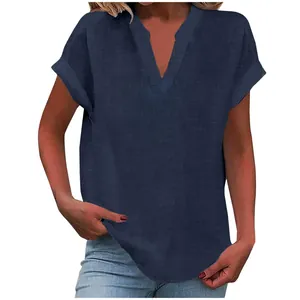 Close-up of navy blue V-neck blouse with rolled short sleeves and linen texture
