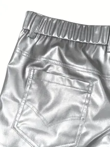 Close-up detail of silver metallic PU leather men's shorts back pocket and elastic waistband