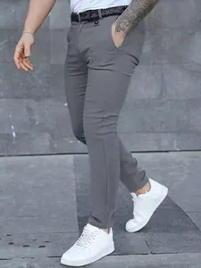 Side view of slim-fit grey casual trousers paired with white sneakers