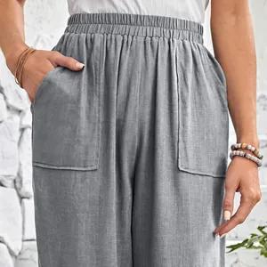Close-up of grey cotton linen pants with elastic waist and large front pockets.