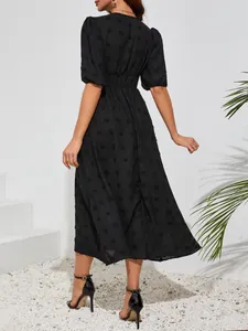 Back view of elegant black textured midi dress with puff sleeves and cinched waist