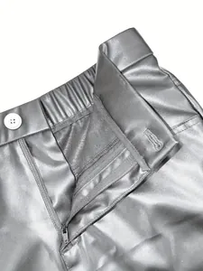 Macro detail of men's metallic silver PU leather shorts featuring zipper and button closure