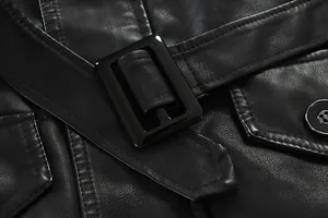 Detailed macro view of black leather trench coat belt buckle and fine stitching details