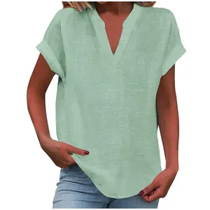 Detail showing the V-neck and folded short sleeves of this light green linen-texture blouse.