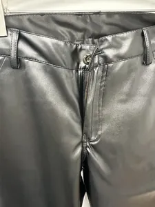 Detailed view of the waist and zipper of men's black slim-fit PU leather trousers