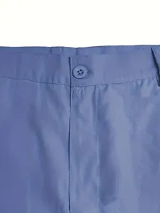 Detail view of men's blue cotton shorts featuring waistband, button, and fabric texture