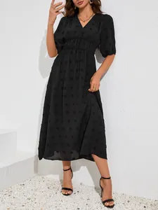 Elegant black V-neck midi dress with Swiss dot texture, puff sleeves and elasticated waist