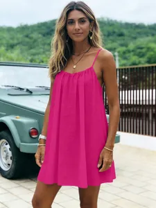 Mini-robe plissée rose vif à bretelles spaghetti pour les vacances à la plage.