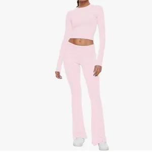 Pink two-piece loungewear set featuring long sleeve crop top and flare pants