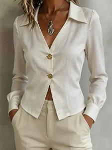 Detail view of a professional off-white long-sleeved blouse with elegant gold buttons.