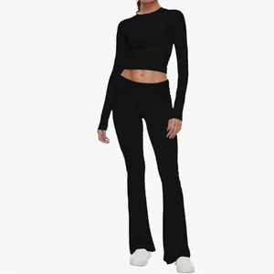 Women's two-piece black yoga set with long sleeve crop top and low waist flare pants