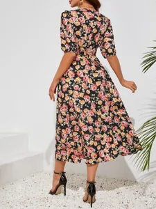 Rear view showing the fit and floral print of this fashionable midi dress with puff sleeves.