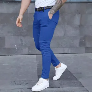 Men's slim fit royal blue casual trousers with white sneakers in urban setting