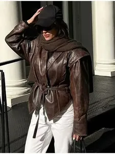 Vintage women's brown leather jacket with shawl collar and waist belt in street style