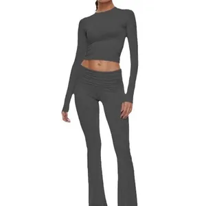 Two-piece gray ribbed knit set featuring a long sleeve crop top and low waist flare pants.