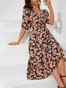 Detail view showing the vibrant floral print and elegant V-neck design of this midi dress.