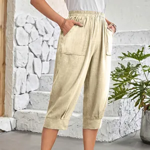Detail of beige cotton linen cropped pants with elastic waist and large side pockets.