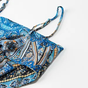 Detailed view of the strap and neckline on this blue paisley printed satin halter top