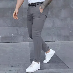 Men's slim-fit business casual grey trousers shown in a stylish outdoor setting