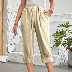 Detail view of light beige cotton linen pants with large pockets and elastic waist