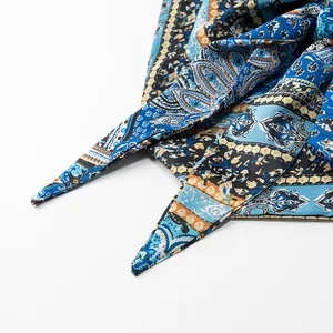 Close-up detail of silk printed halter top featuring vintage blue and orange paisley pattern