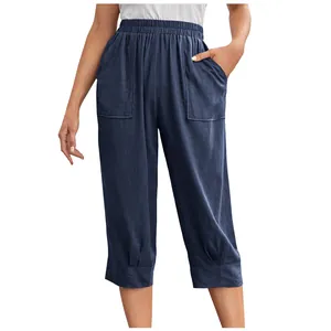 Close-up detail of women's dark blue cotton linen loose pants with large patch pockets