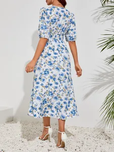 Back view of a white midi dress with elegant blue floral print and puff sleeves