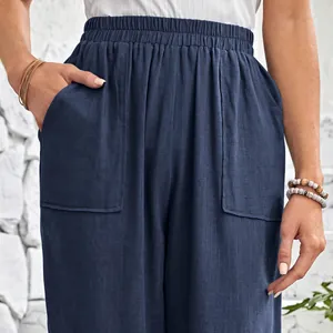 Detailed view of navy blue cotton linen pants featuring elastic waist and large patch pockets